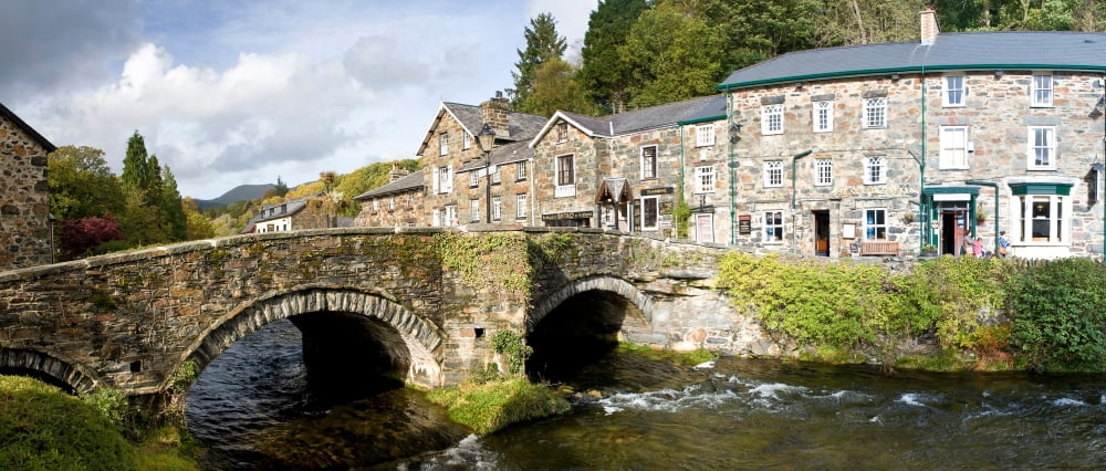 Bridge with houses at Beddgelert Snowdonia Gwynedd Wales Canvas Art - Panoramic Images (22 x 9)