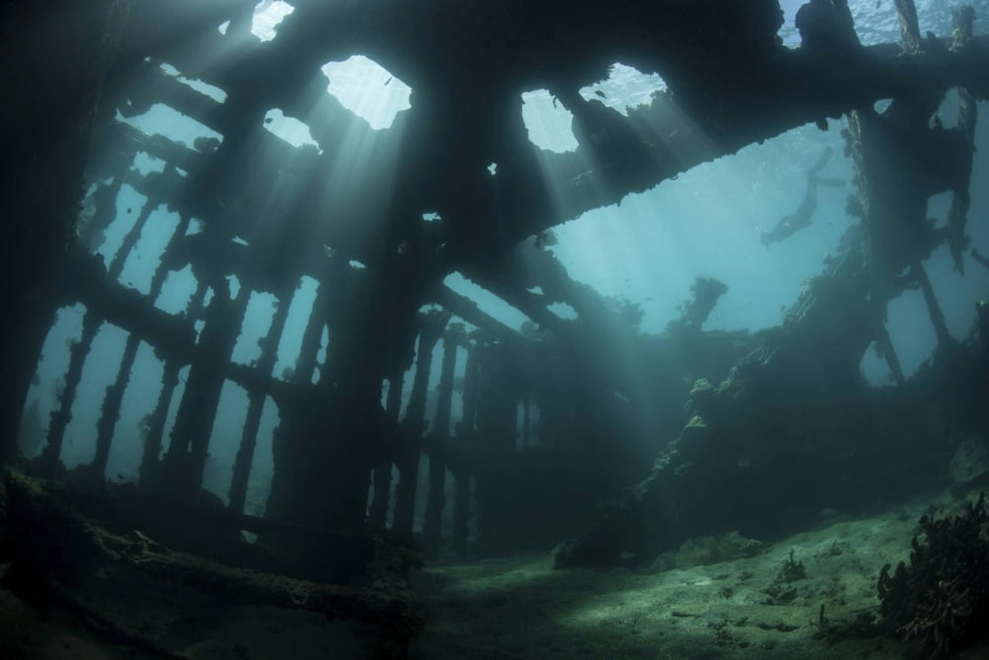 Bright sunlight pierces a shallow World War II shipwreck Canvas Art - Ethan DanielsStocktrek Images (34 x 23)