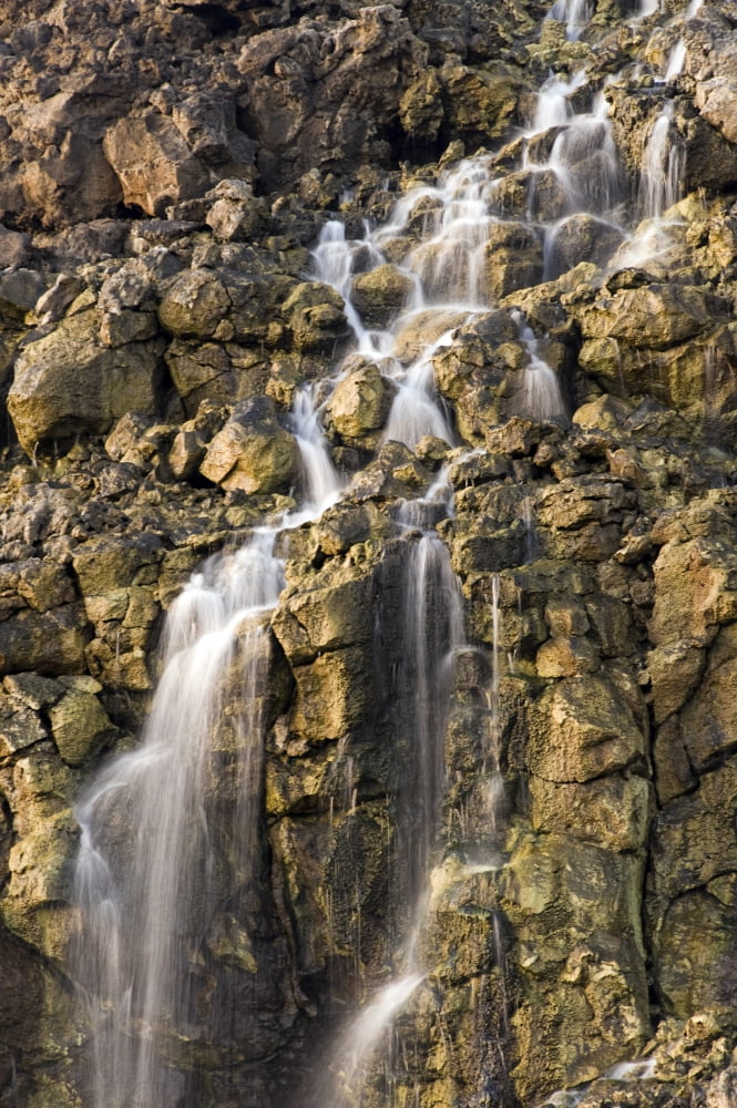 Brine falls from volcanic rock drop off to a runoff stream Canvas Art - Stocktrek Images (23 x 34)