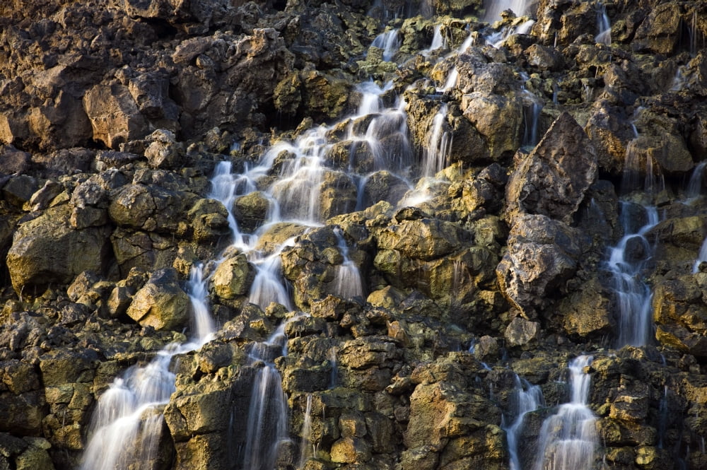 Brine falls from volcanic rock drop off to a runoff stream Canvas Art - Stocktrek Images (34 x 23)