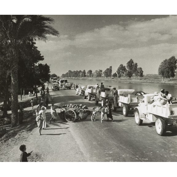 British Army Moves To Forward Areas Around El Alamein And El Darba. Egyptian Villagers Watching A Large British Convoy Of Military Trucks Traveling Along The Road To The Western Desert During World