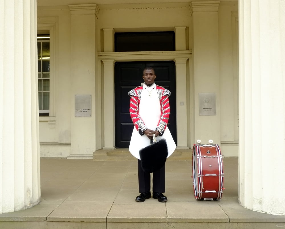 British Royal Guard standing by his drum between a colonnade Canvas Art - Andrew ChittockStocktrek Images (32 x 26)
