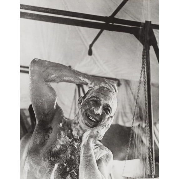 British Soldier In The Western Showers In A Mobile Bath Unit. The Mobile Unit Carried Its Own Water Supply As It Traveled To Soldiers Locations In The Libyan Desert During World War 2. Ca. 1940-42.