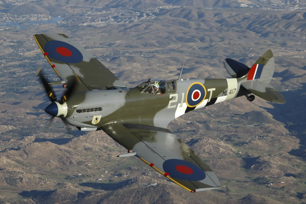 British Supermarine Spitfire Mk-16 flying over Northern California coastline Canvas Art - Phil WallickStocktrek Images (34 x 23)