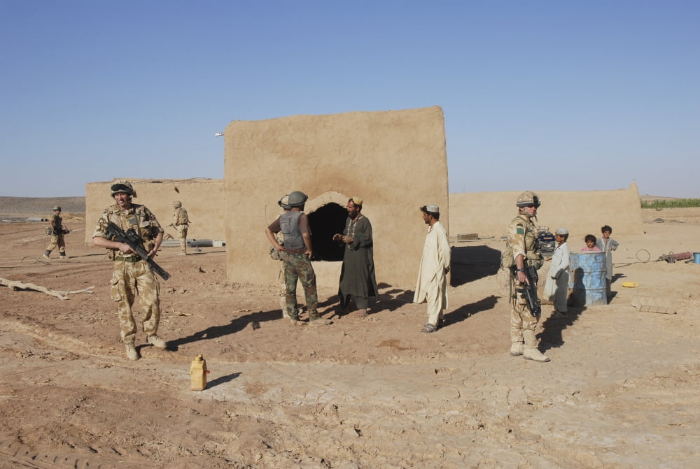 British soldiers on foot patrol outside Camp Bastion Afghanistan Canvas Art - Andrew ChittockStocktrek Images (17 x 12)