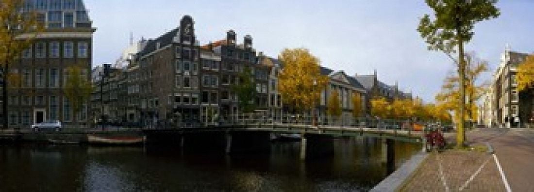 Buildings along a canal Amsterdam Netherlands Canvas Art - Panoramic Images (18 x 7)