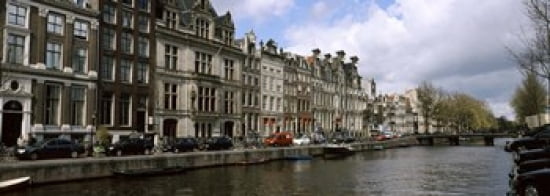 Buildings along a canal Amsterdam Netherlands Canvas Art - Panoramic Images (36 x 13)