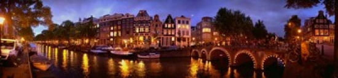 Buildings along a canal at dusk Amsterdam Netherlands Canvas Art - Panoramic Images (20 x 5)
