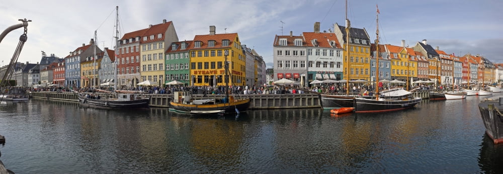 Buildings along a canal with boats Nyhavn Copenhagen Denmark Canvas Art - Panoramic Images (13 x 36)