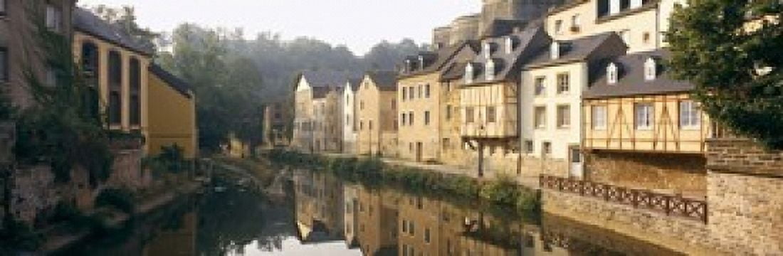 Buildings along a river Alzette River Luxembourg City Luxembourg Canvas Art - Panoramic Images (18 x 6)