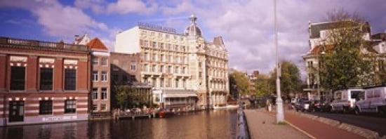 Buildings along a water channel Amsterdam Netherlands Canvas Art - Panoramic Images (36 x 13)
