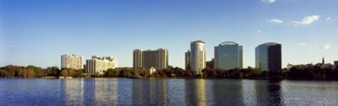 Buildings at the waterfront Lake Eola Orlando Orange County Florida USA 2010 Canvas Art - Panoramic Images (18 x 6)