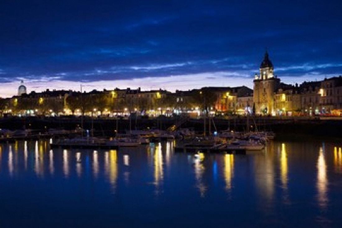 Buildings at the waterfront lit up at dusk Old Port La Rochelle Charente-Maritime Poitou-Charentes France Canvas Art - Panoramic Images (36 x 24)