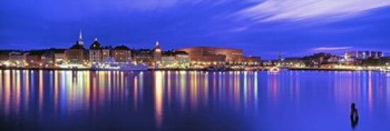 Buildings at the waterfront lit up at dusk Stockholm Sweden Canvas Art - Panoramic Images (36 x 12)