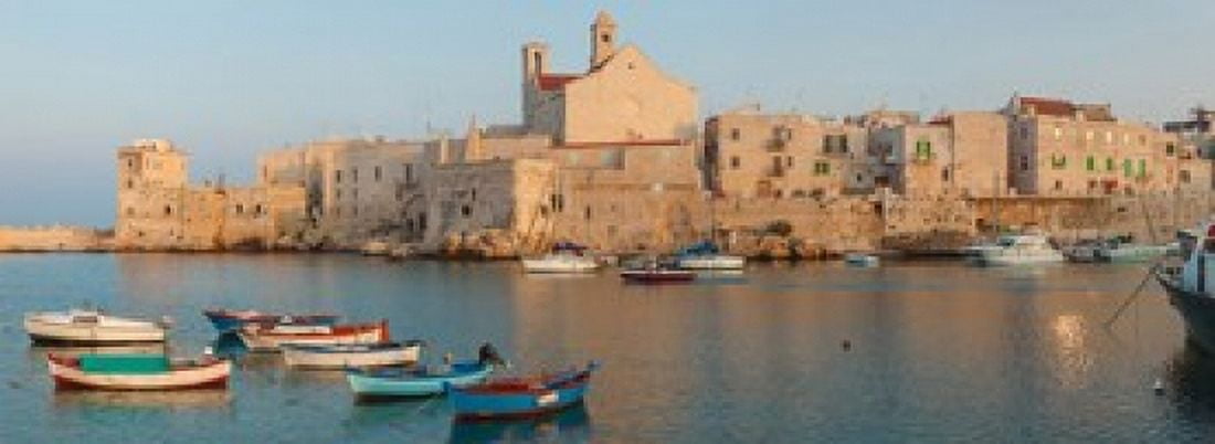 Buildings at the waterfront with boats at harbor Giovinazzo Puglia Italy Canvas Art - Panoramic Images (36 x 13)