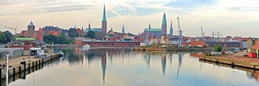 Buildings at the waterfront with church towers in distance Trave River Lubeck Schleswig-Holstein Germany Canvas Art - Panoramic Images (18 x 6)