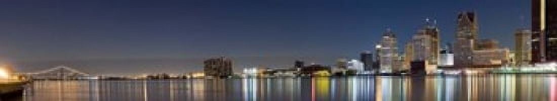 Buildings in a city lit up at dusk Detroit River Detroit Michigan USA Canvas Art - Panoramic Images (22 x 4)