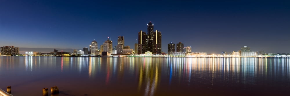 Buildings in a city lit up at dusk Detroit River Detroit Michigan USA Canvas Art - Panoramic Images (27 x 9)