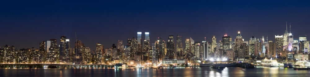 Buildings in a city lit up at dusk Hudson River Midtown Manhattan Manhattan New York City New York State USA Canvas Art - Panoramic Images (36 x 9)