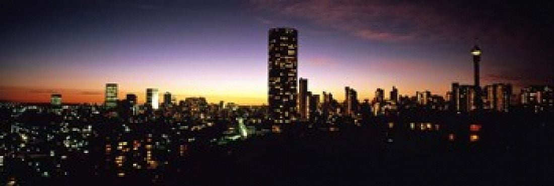 Buildings in a city lit up at night Johannesburg South Africa Canvas Art - Panoramic Images (18 x 6)