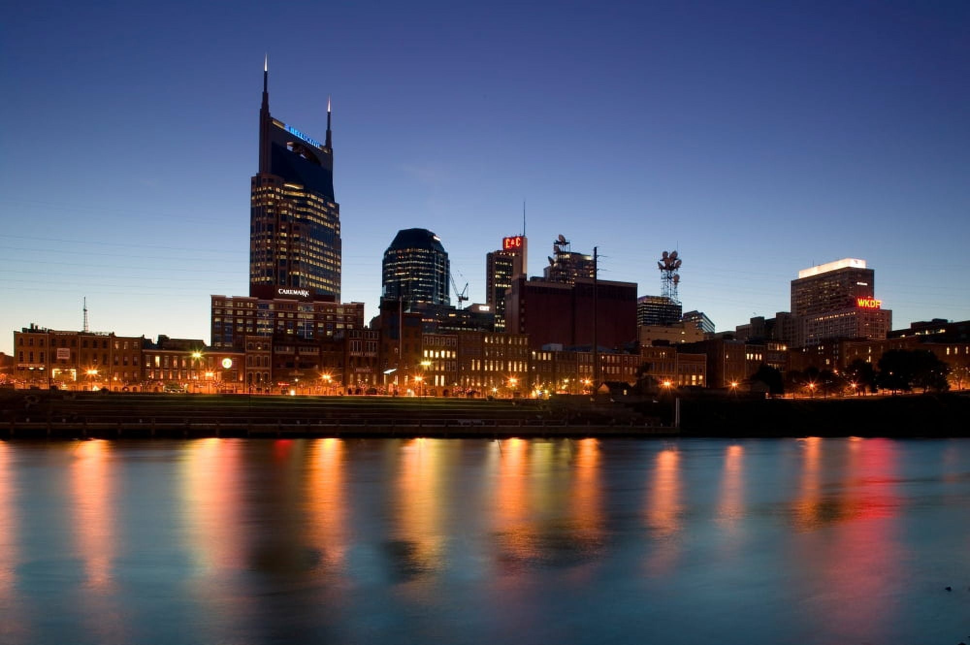 Buildings lit up at dusk at the waterfront Cumberland River Bell South Tower Nashville Tennessee USA Canvas Art - Panoramic Images (27 x 9)