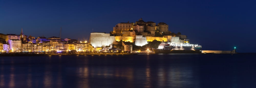 Buildings lit up at night Calvi Balagne Haute-Corse Corsica France Canvas Art - Panoramic Images (9 x 27)