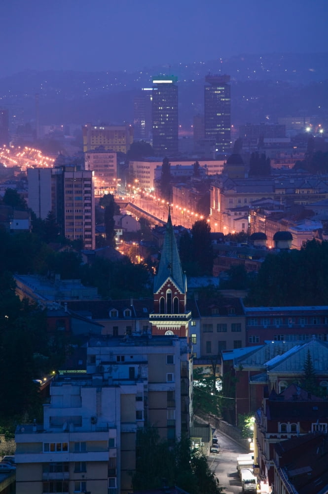 Buildings lit up at night in a city Sarajevo Bosnia and Hercegovina Canvas Art - Panoramic Images (36 x 12)