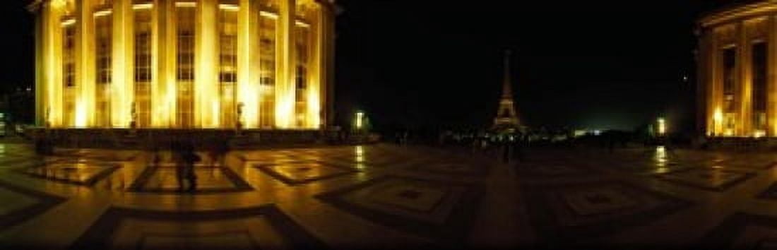 Buildings lit up at night with a tower in the background Eiffel Tower Paris France Canvas Art - Panoramic Images (18 x 6)