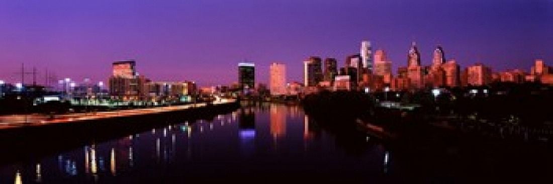 Buildings lit up at the waterfront Philadelphia Schuylkill River Pennsylvania USA Canvas Art - Panoramic Images (18 x 6)