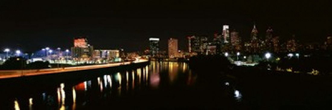 Buildings lit up at the waterfront Philadelphia Schuylkill River Pennsylvania USA Canvas Art - Panoramic Images (18 x 6)