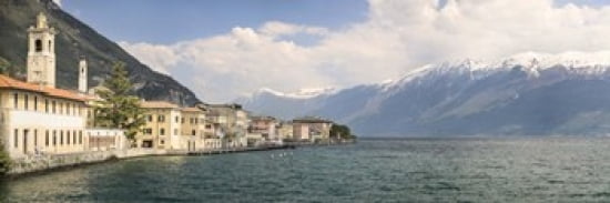Buildings at the waterfront with snowcapped mountain in the background Gargnano Monte Baldo Lake Garda Lombardy Italy Canvas Art - Panoramic Images (36 x 12)