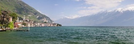 Buildings at the waterfront with snowcapped mountain in the background Gargnano Monte Baldo Lake Garda Lombardy Italy Canvas Art - Panoramic Images (36 x 12)