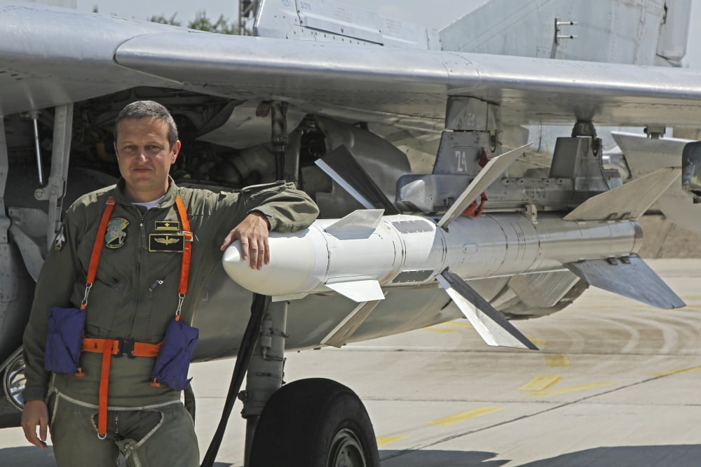 Bulgarian Air Force pilot stands next to an AA-10 Alamo missile Canvas Art - Anton BalakchievStocktrek Images (18 x 12)