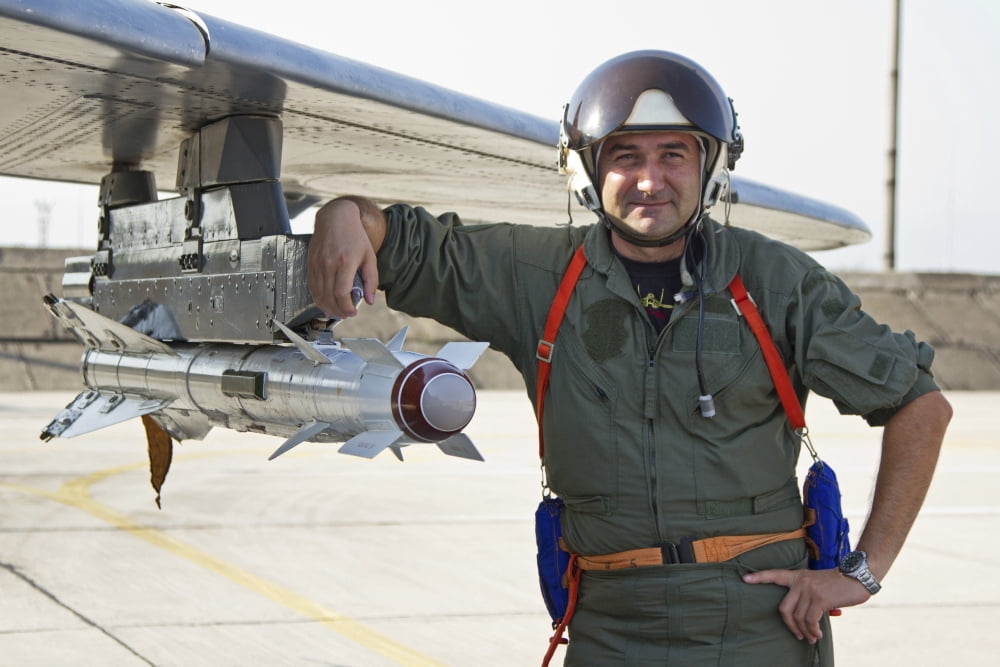 Bulgarian Air Force pilot stands next to an AA-8 Aphid missile Canvas Art - Anton BalakchievStocktrek Images (35 x 23)