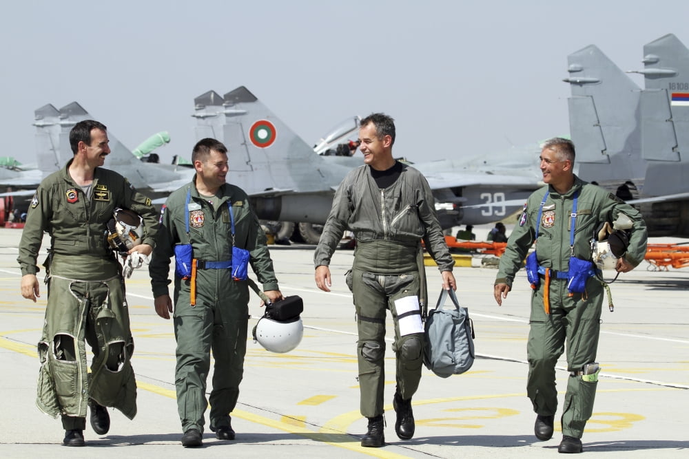 Bulgarian and Serbian Air Force pilots walking away from their aircraft Canvas Art - Anton BalakchievStocktrek Images (35 x 23)