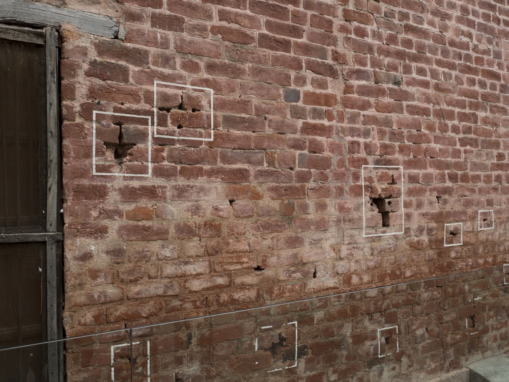 Bullet holes outlined in white paint at site of April 13, 1919 massacre