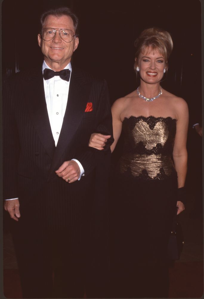 Burt Sugarman In Tuxedo And Mary Hart In Black And Gold Strapless Gown