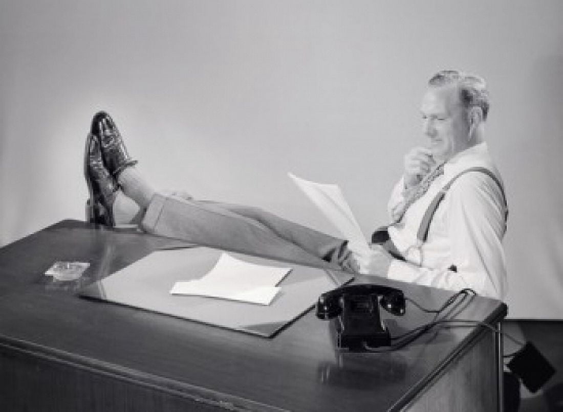 Business man reading in office with feet up on desk Canvas Art - (18 x 24)