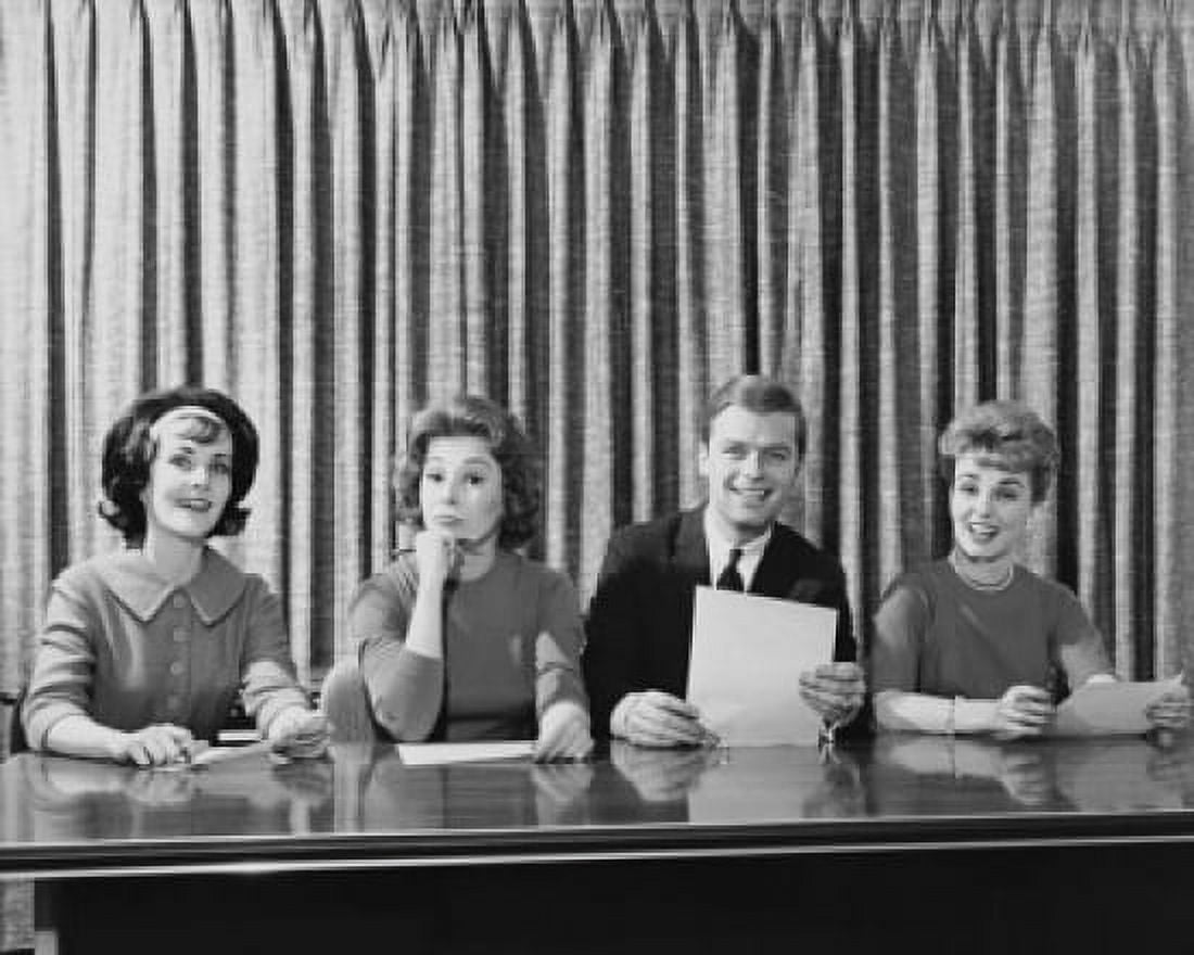 Businessman and three businesswomen sitting at a table Canvas Art - (24 x 36)