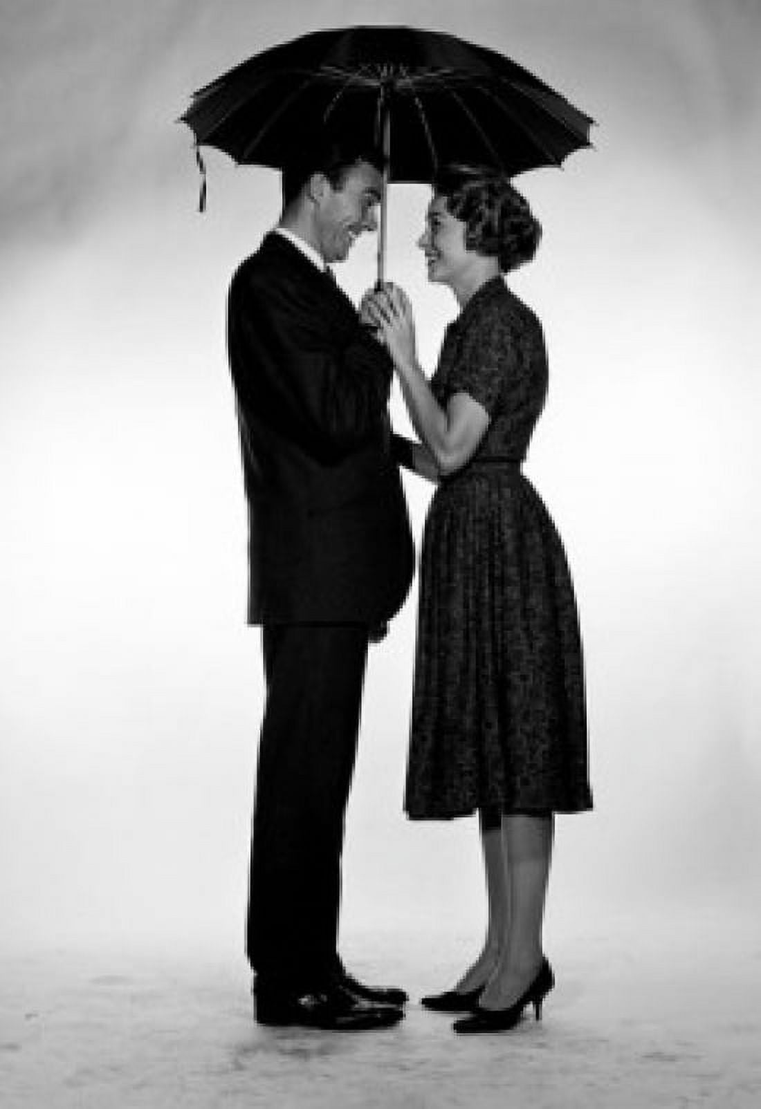 Businessman and woman standing under umbrella Canvas Art - (18 x 24)