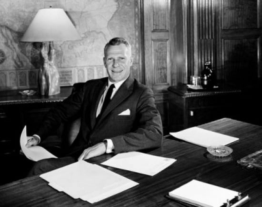 Businessman at desk holding documents Canvas Art - (24 x 36)