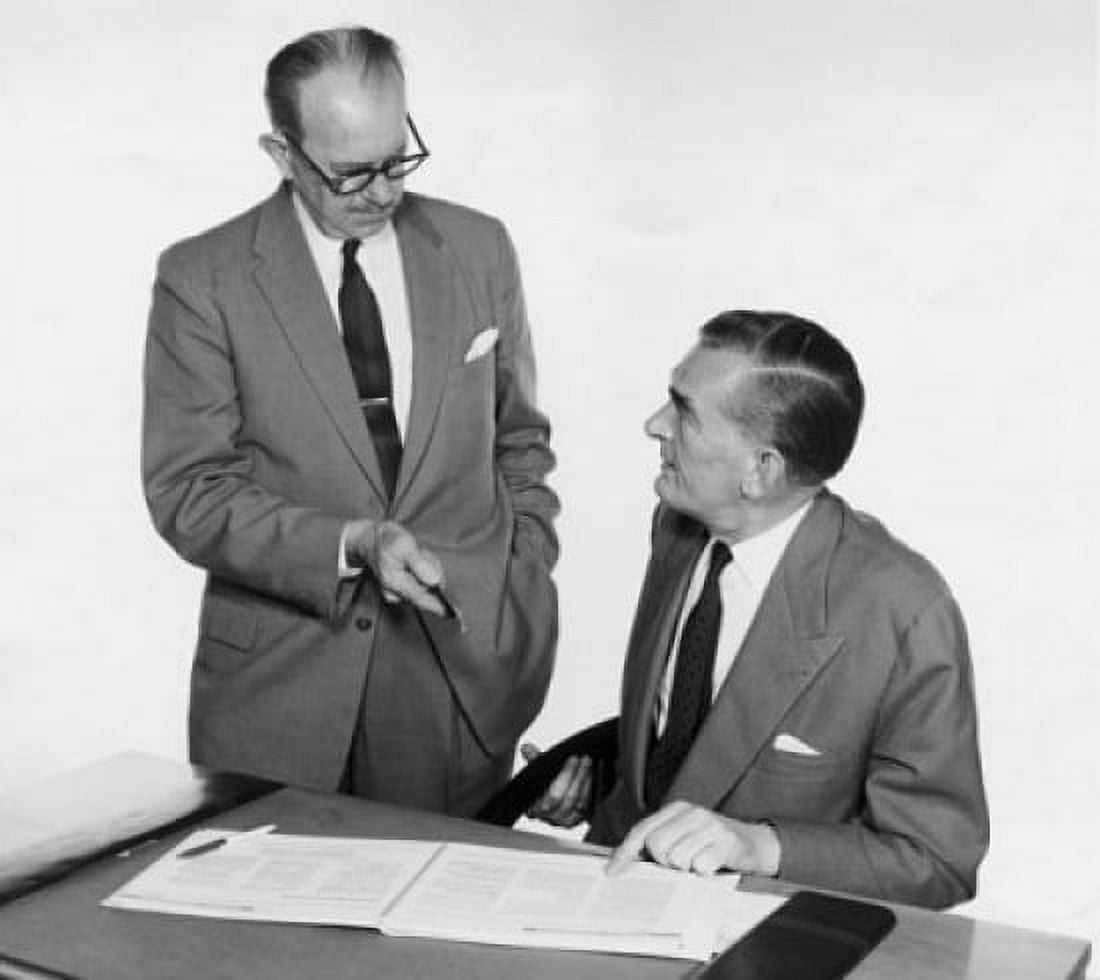Businessman discussing over documents Canvas Art - (18 x 24)