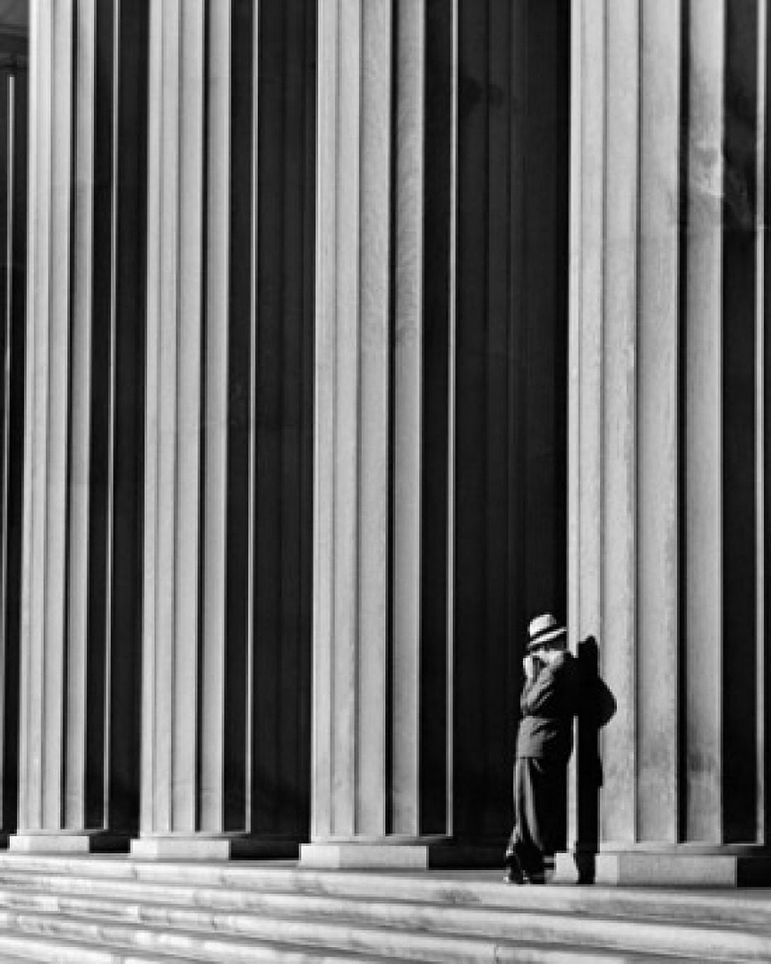 Businessman leaning against a column Canvas Art - (18 x 24)
