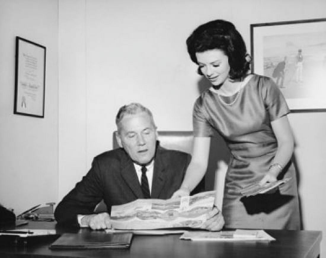 Businessman looking at a map with his secretary standing beside him Canvas Art - (18 x 24)