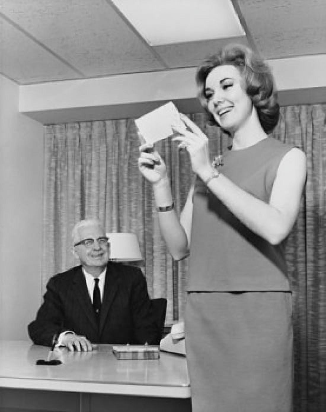 Businessman looking at his secretary holding a check and smiling in an office Canvas Art - (18 x 24)