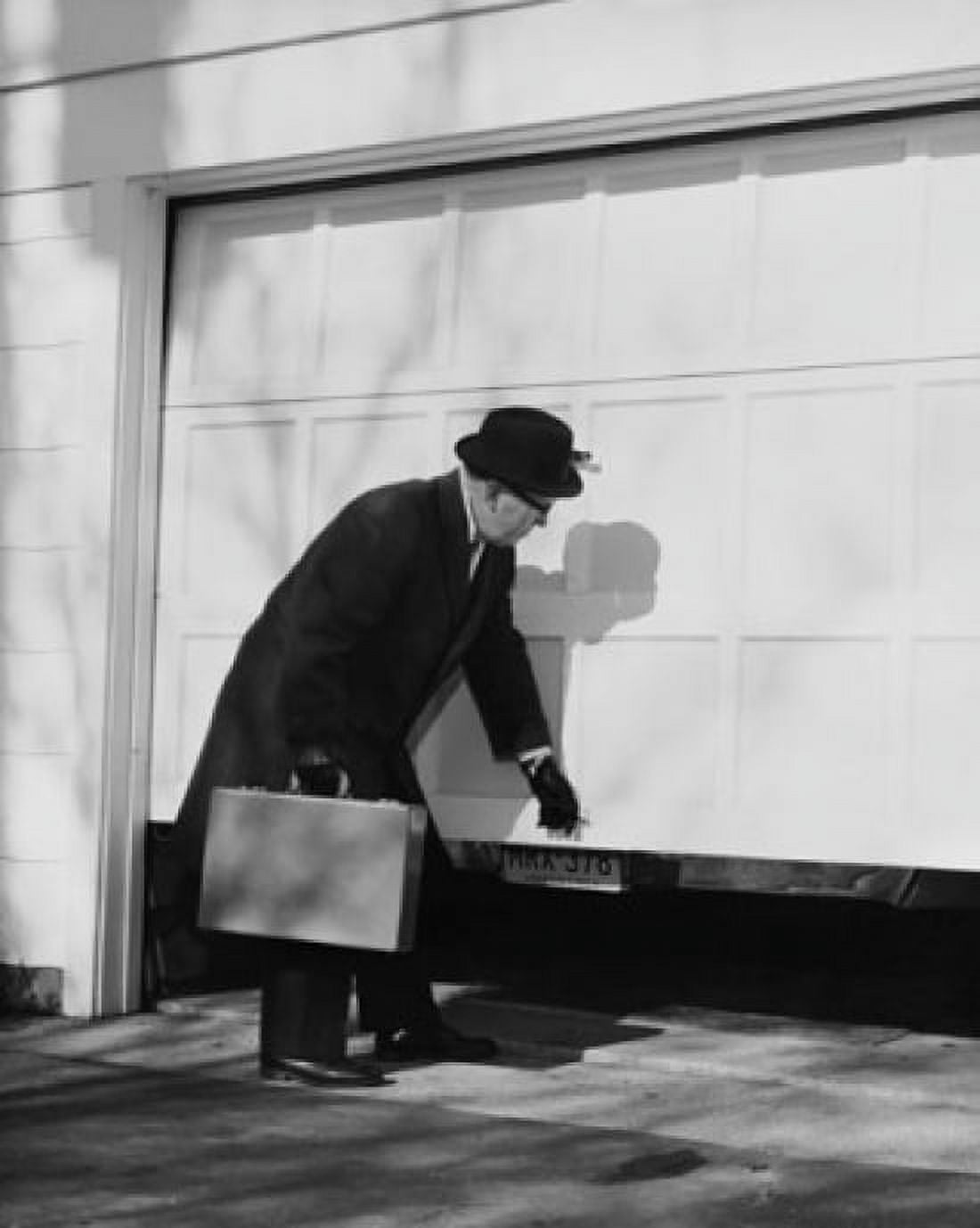 Businessman opening a garage door Canvas Art - (24 x 36)