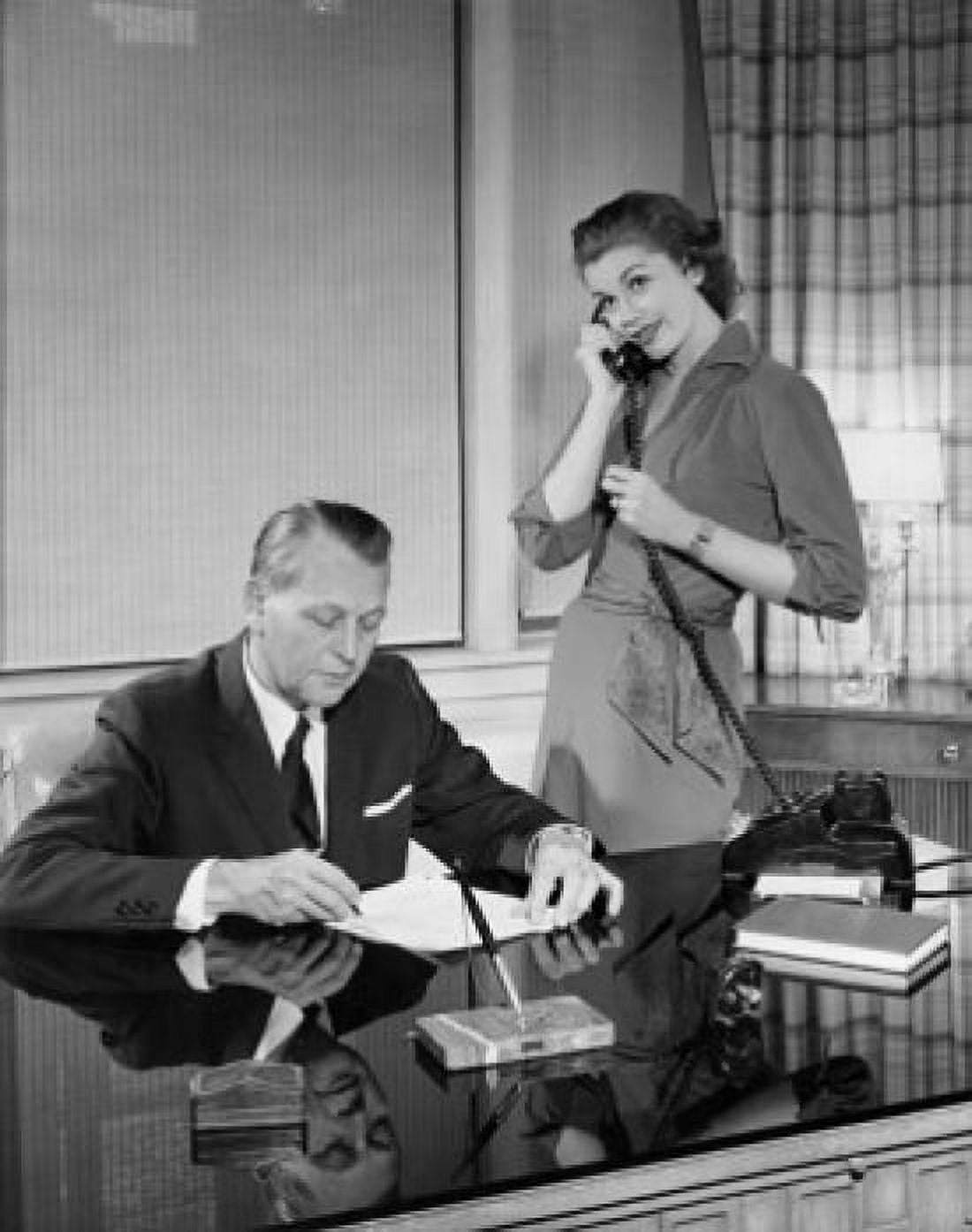 Businessman reading a document and his secretary talking on the telephone beside him Canvas Art - (18 x 24)
