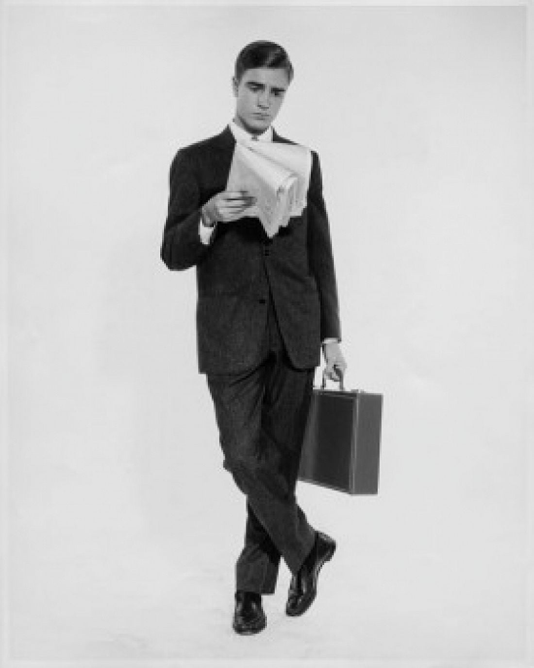 Businessman reading a newspaper and holding a briefcase Canvas Art - (18 x 24)