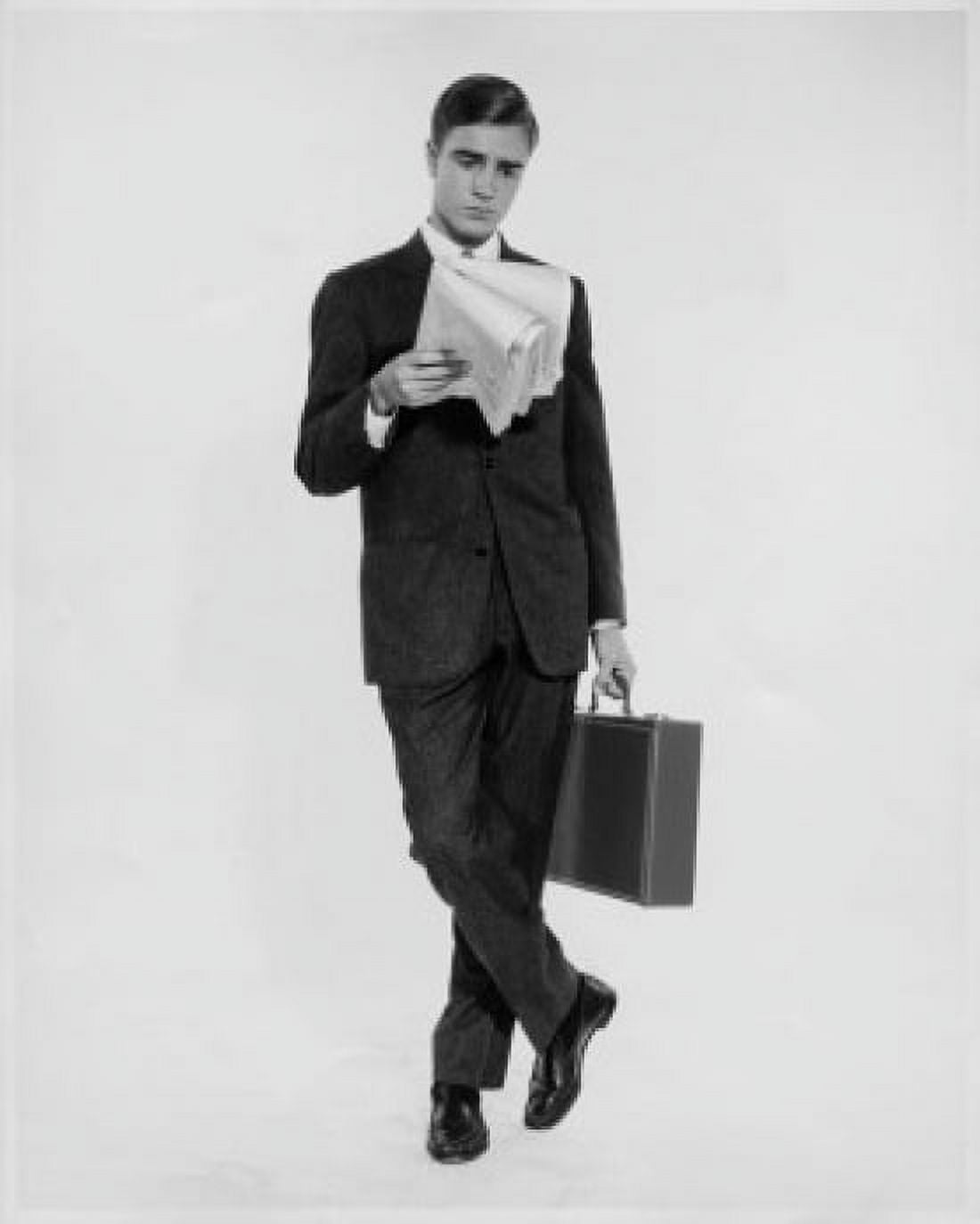 Businessman reading a newspaper and holding a briefcase Canvas Art - (24 x 36)