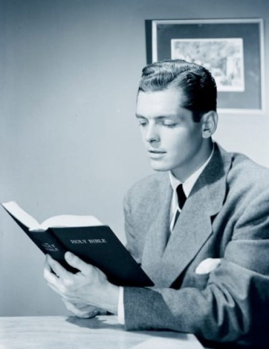 Businessman reading bible in office Canvas Art - (18 x 24)